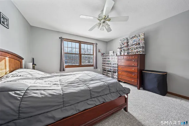 a bedroom with a large bed and a chandelier