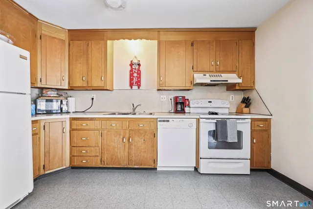 a kitchen with stainless steel appliances granite countertop a sink and cabinets
