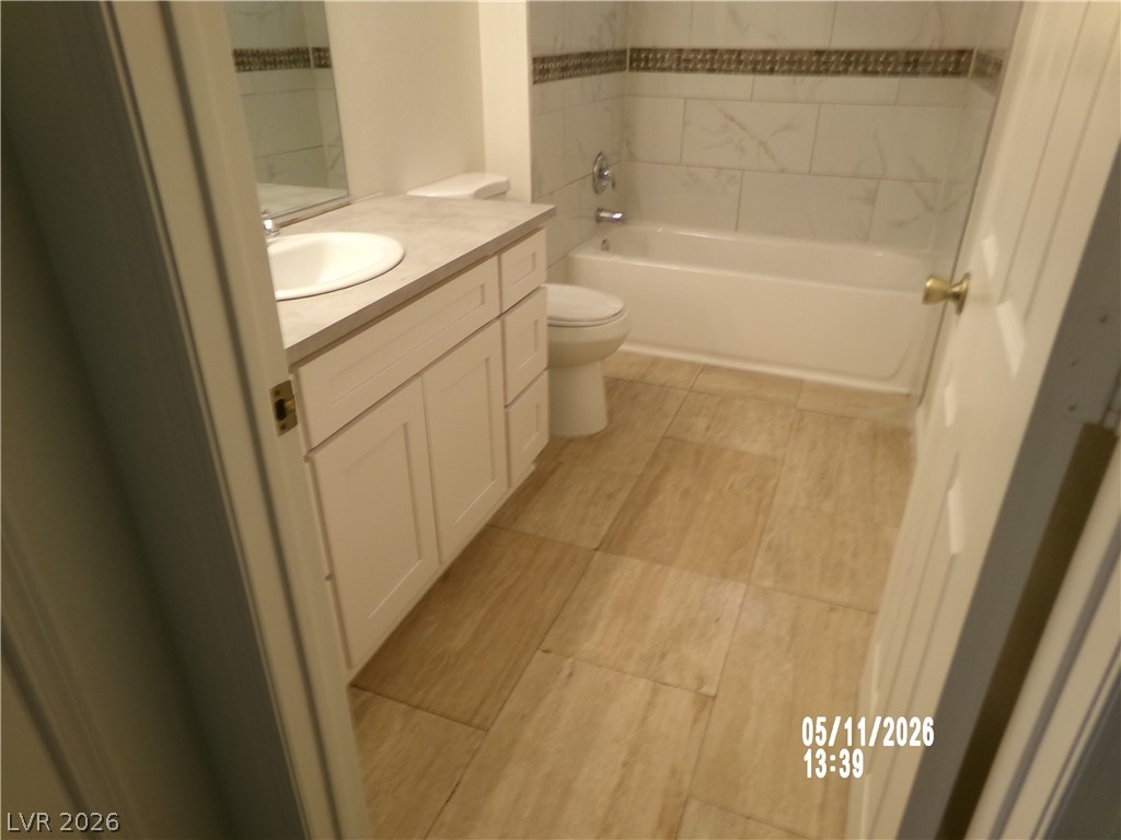 2995 East Sunset Road, Unit 222 Las Vegas, NV 89120 - Photo 21 of 29 This bright bathroom features a vanity with a sleek countertop and a clean, inviting bathtub.