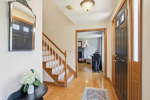 a view of entryway livingroom and hall with wooden floor