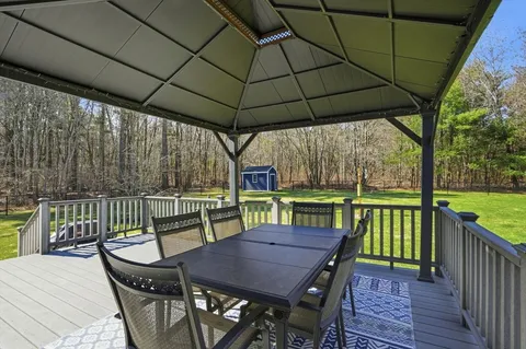 a view of sitting area with furniture and umbrella