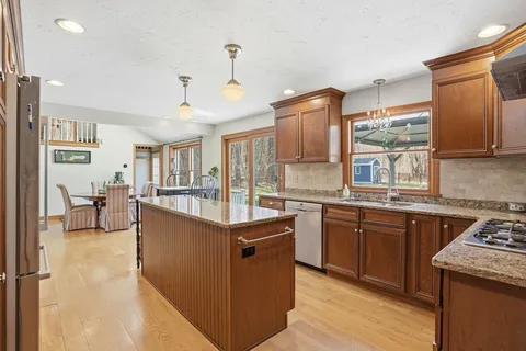 a kitchen with stainless steel appliances granite countertop a sink stove and refrigerator