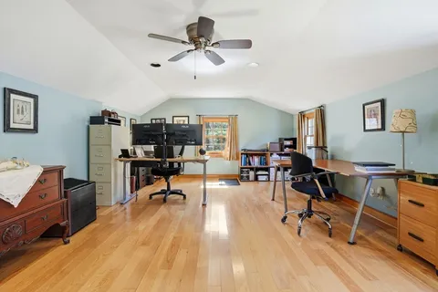 a view of a workspace with furniture and a window