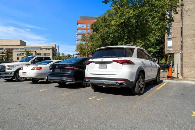 a white car parked in front of a house