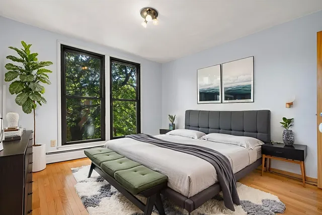 a bedroom with a bed and a window