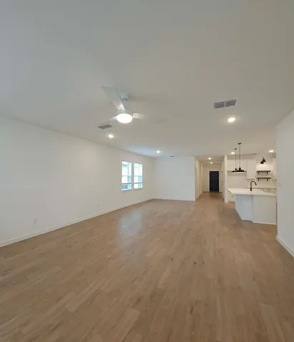 a view of a kitchen with a sink and a window