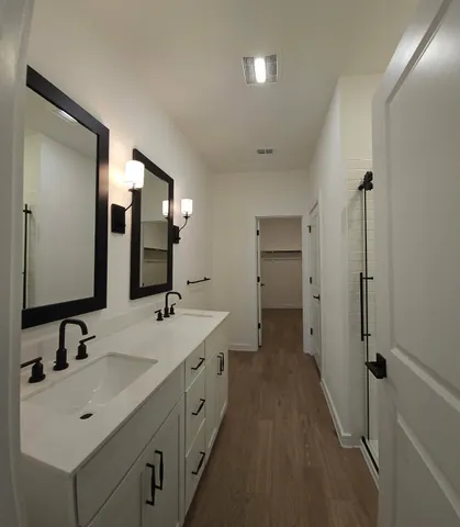 a spacious bathroom with a double vanity sink mirror and double