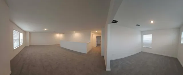 en empty room with windows and closet