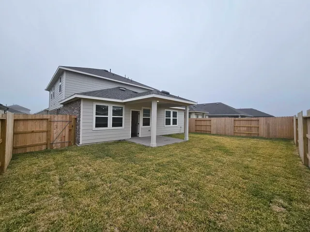 a view of a house with a yard and porch