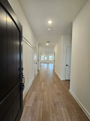 a view of hallway with wooden floor