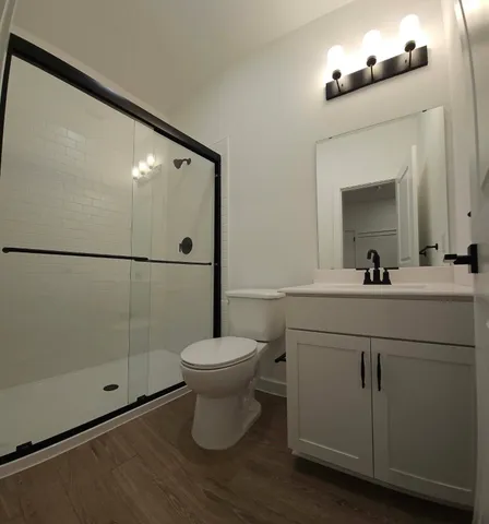 a bathroom with a toilet a sink and mirror