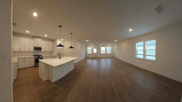 a view of kitchen with sink and wooden floor