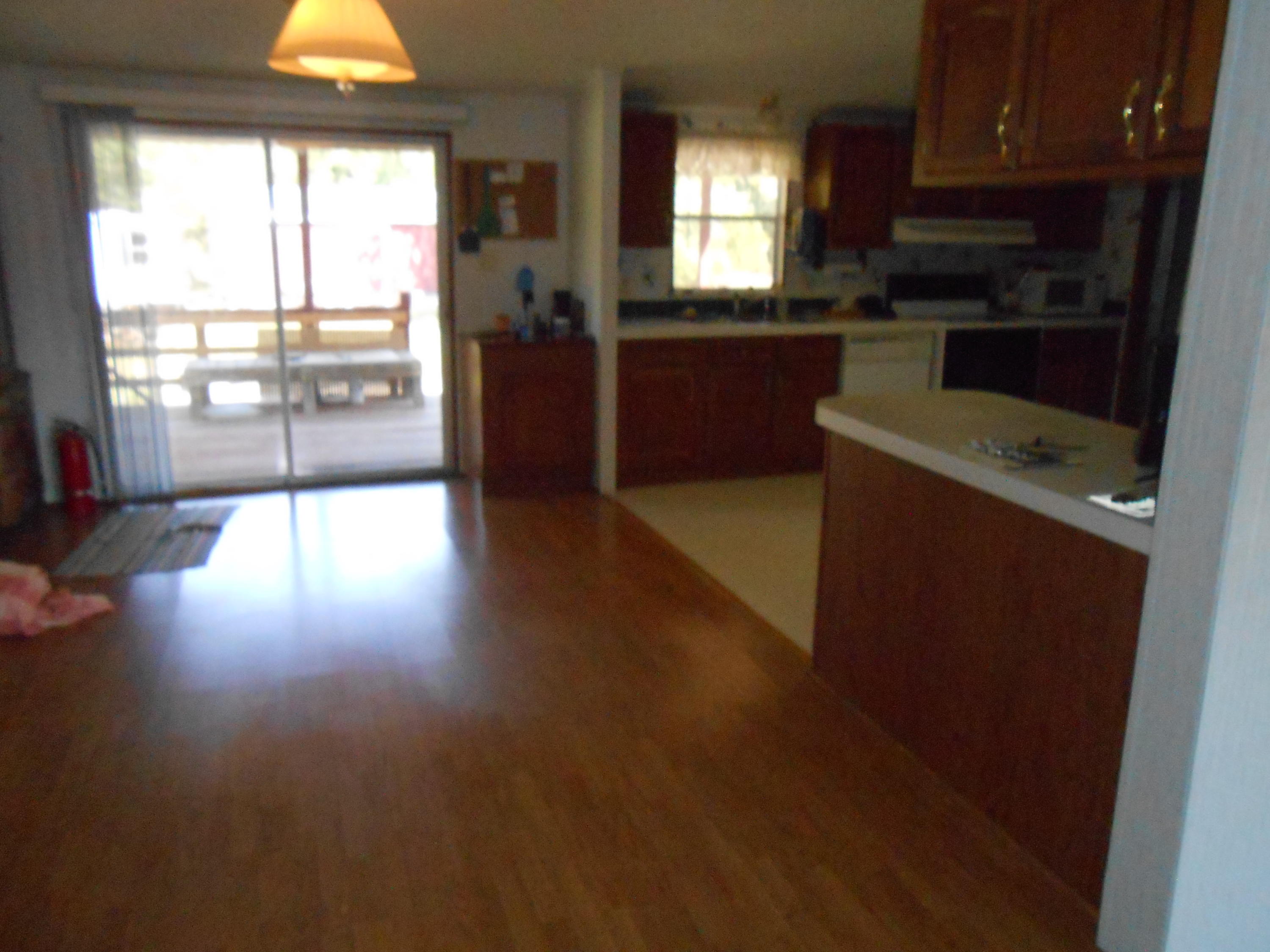 93 West Raphael Road DeFuniak Springs, FL 32433 - Photo 14 of 27 a kitchen with kitchen island granite countertop a stove top oven a sink with wooden floors