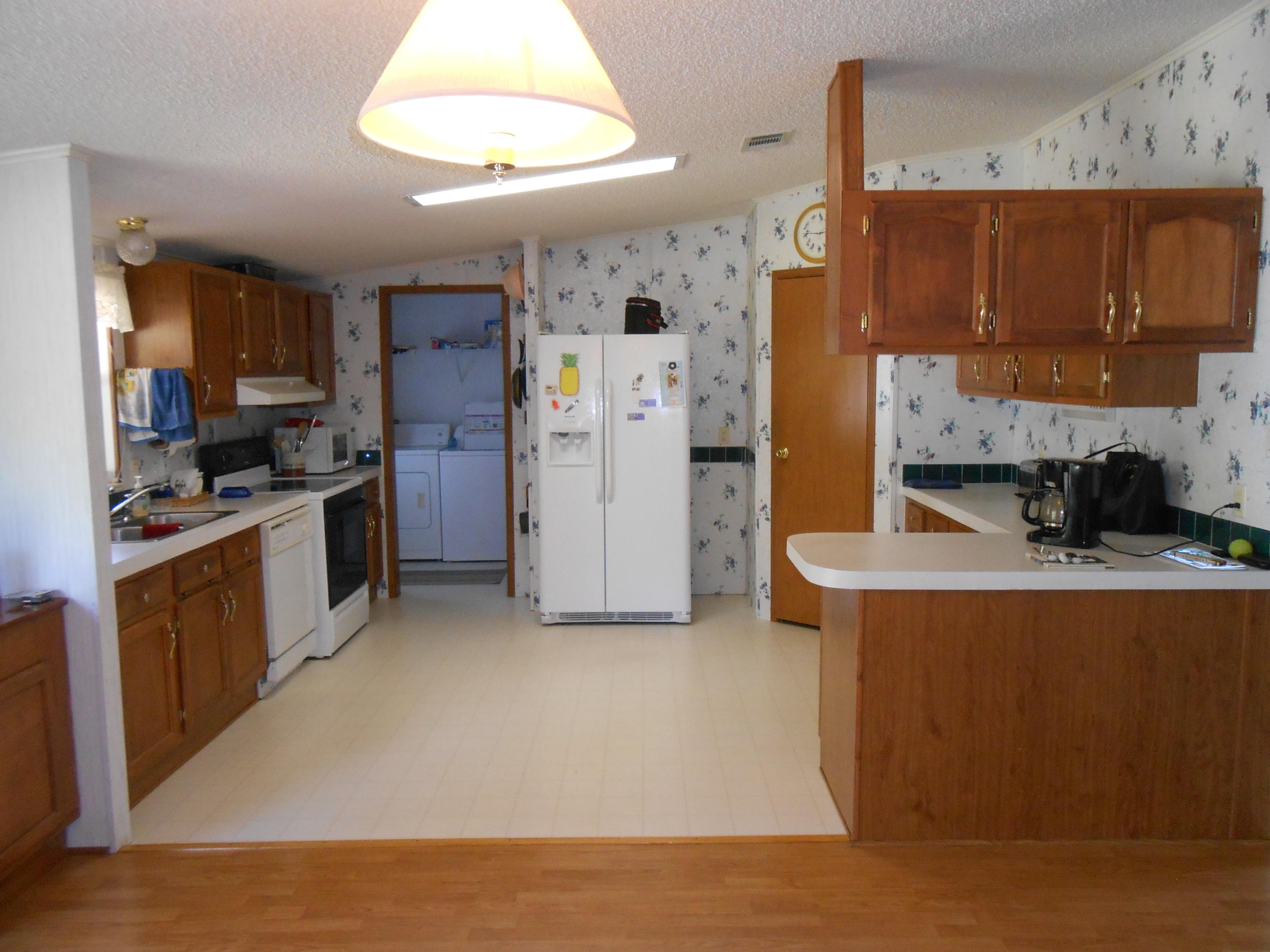 93 West Raphael Road DeFuniak Springs, FL 32433 - Photo 15 of 27 a kitchen with stainless steel appliances a stove refrigerator sink and cabinets
