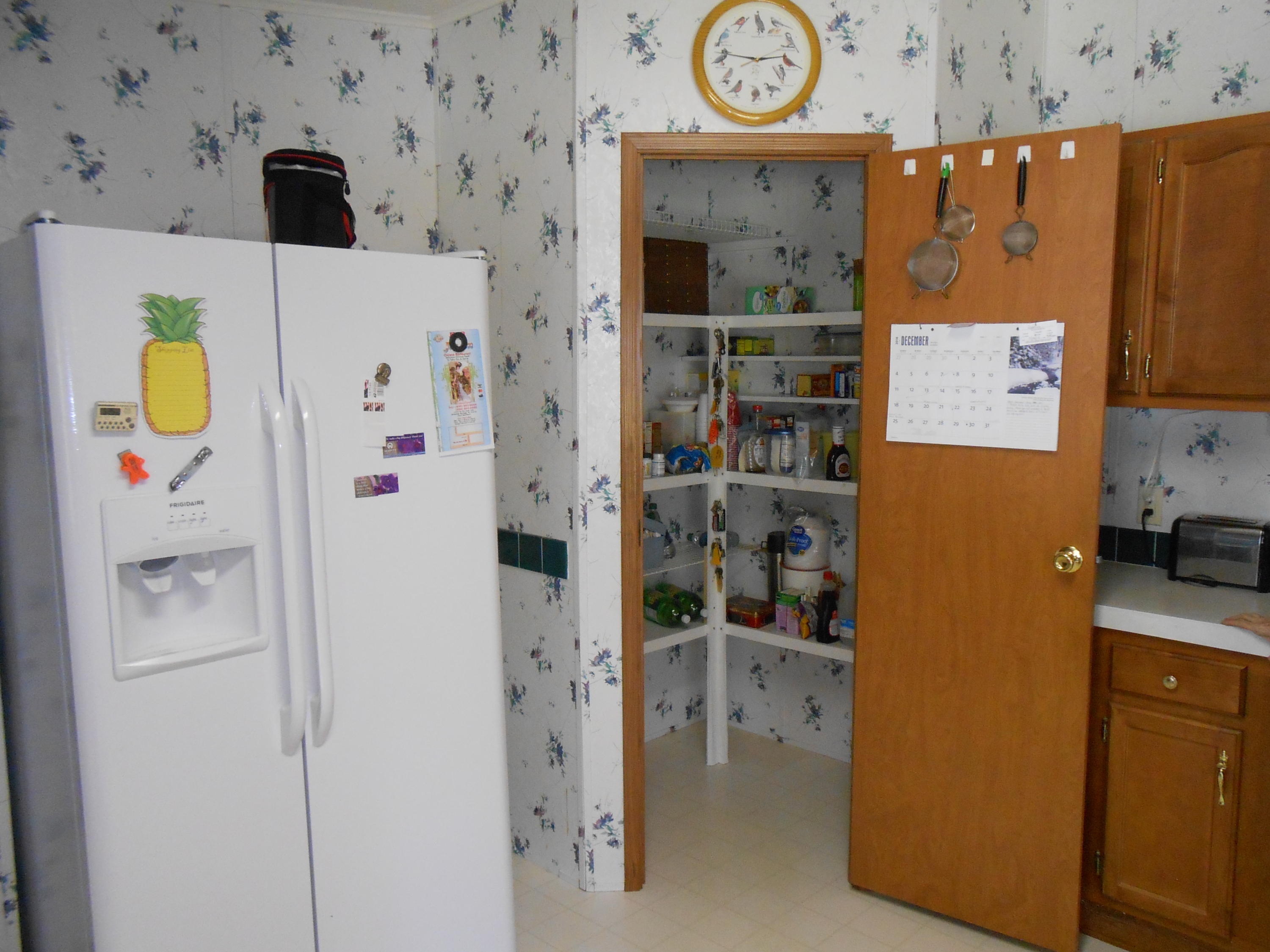 93 West Raphael Road DeFuniak Springs, FL 32433 - Photo 18 of 27 a white refrigerator freezer sitting in a kitchen