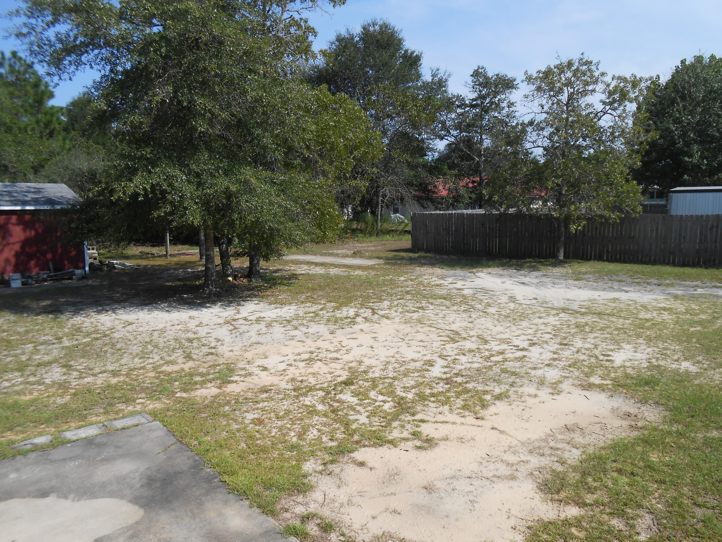 93 West Raphael Road DeFuniak Springs, FL 32433 - Photo 3 of 27 a backyard of a house with a tree