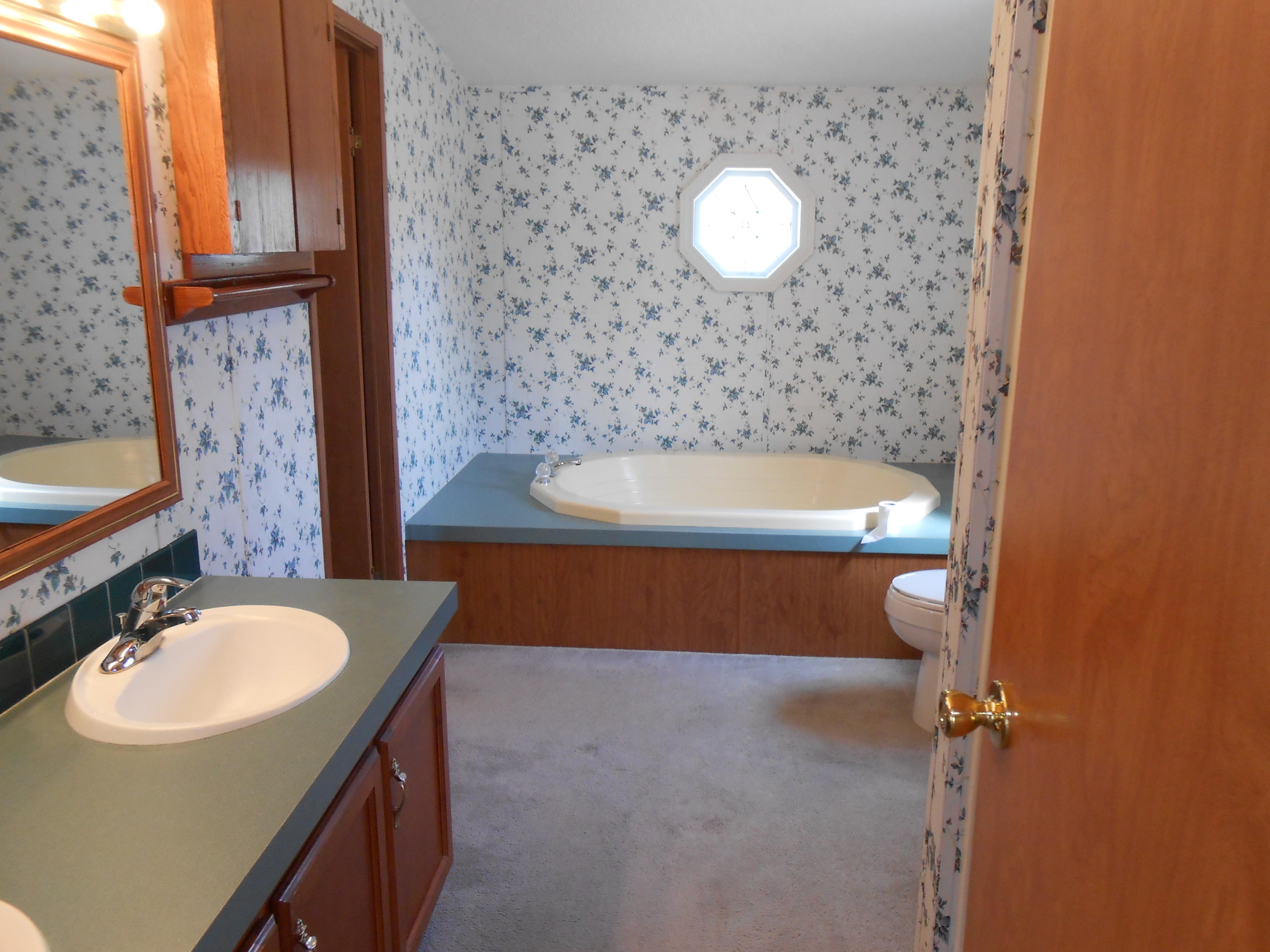 93 West Raphael Road DeFuniak Springs, FL 32433 - Photo 10 of 27 a bathroom with a sink and a mirror