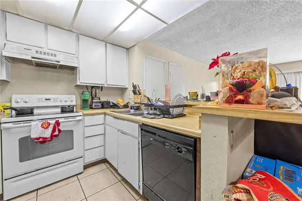 a kitchen with refrigerator and cabinets