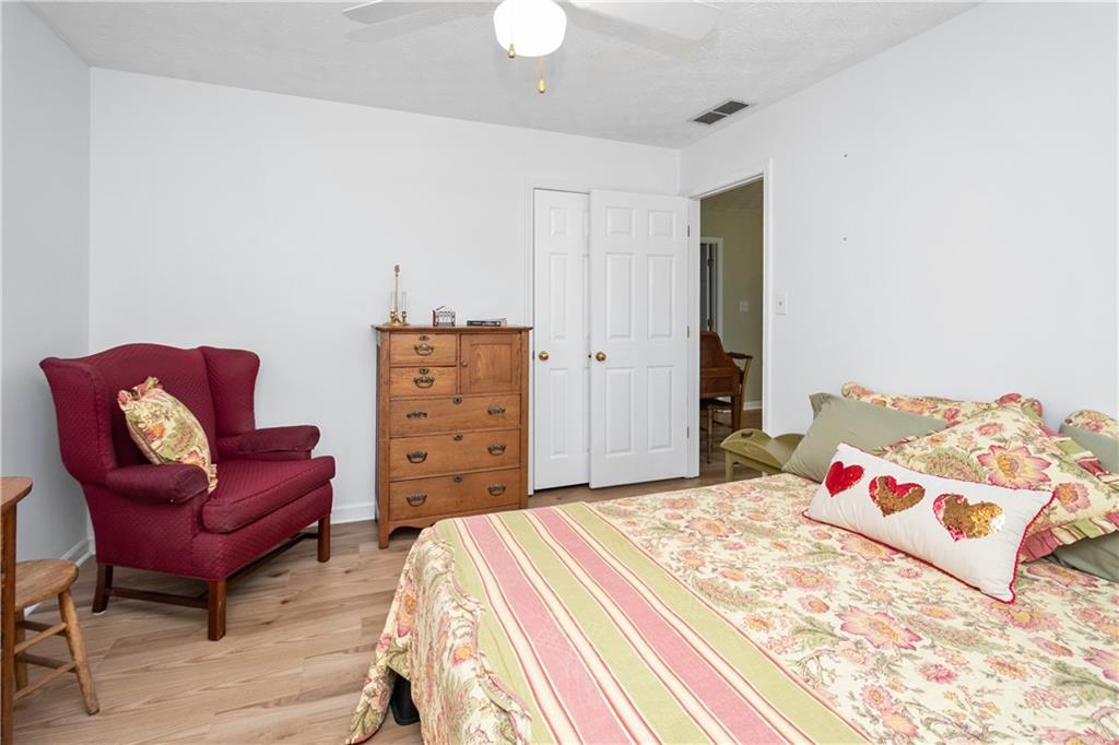 405 Ridgemont Drive Fayetteville, GA 30215 - Photo 31 of 43 a bedroom with a bed and a chair