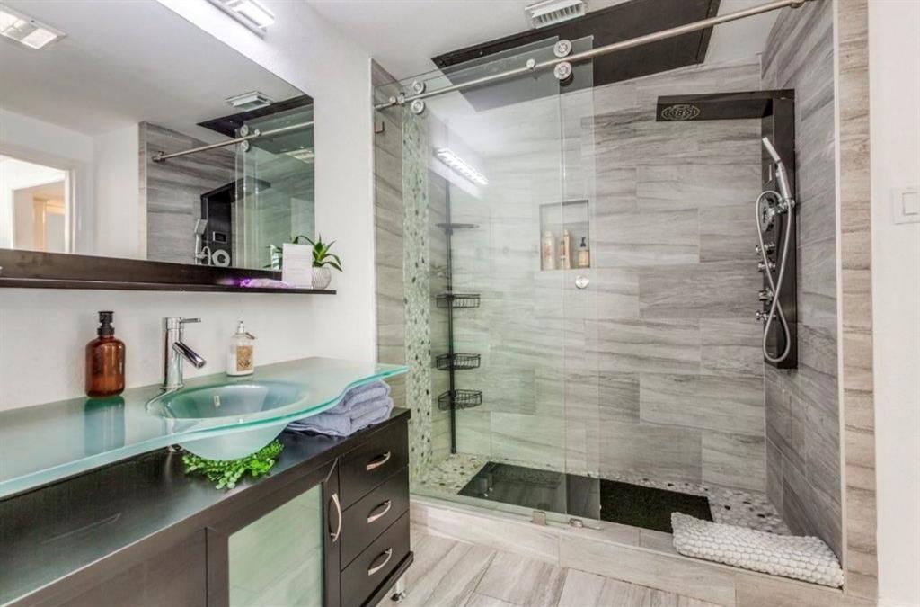 3550 Country Square Drive, Unit 109 Carrollton, TX 75006 - Photo 11 of 13 Bathroom featuring vanity and a shower stall