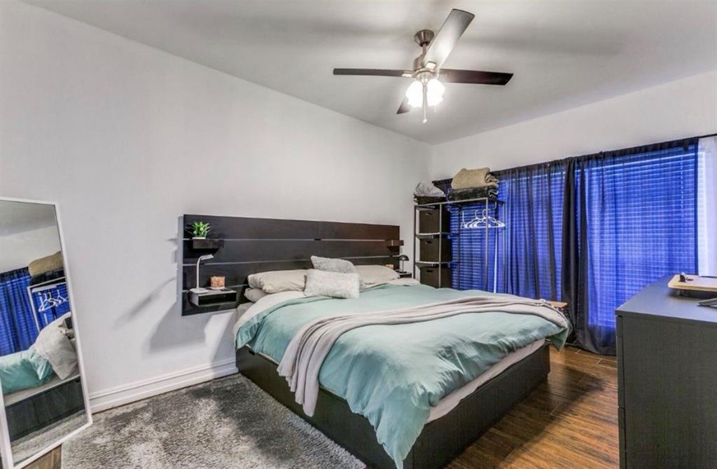 3550 Country Square Drive, Unit 109 Carrollton, TX 75006 - Photo 8 of 13 Bedroom featuring a ceiling fan and dark wood finished floors