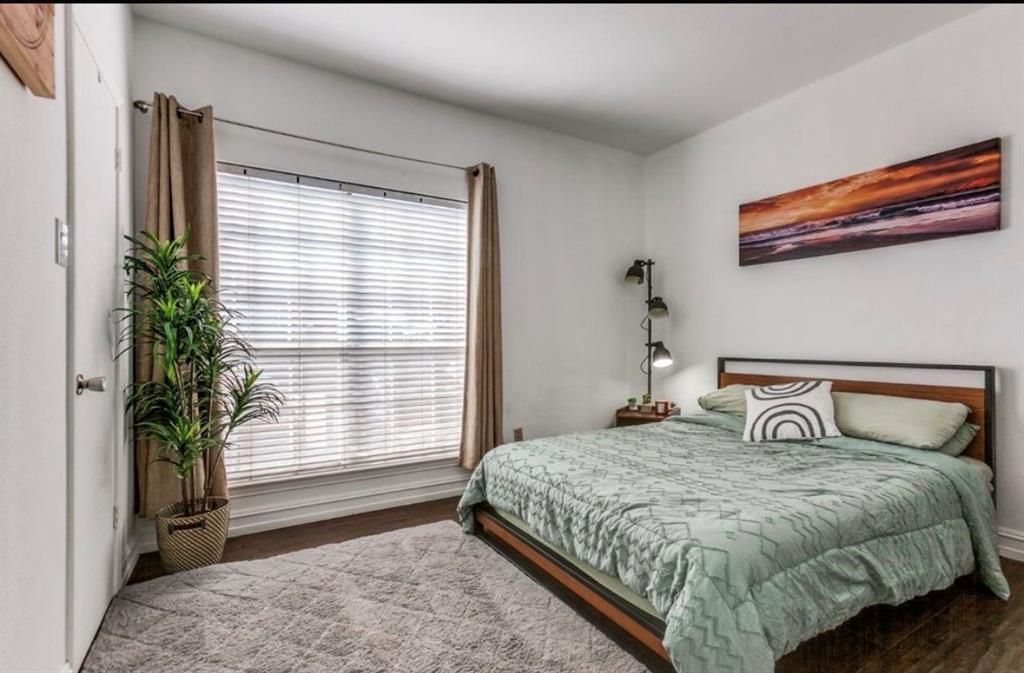 3550 Country Square Drive, Unit 109 Carrollton, TX 75006 - Photo 10 of 13 Bedroom with wood finished floors