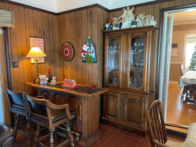 a view of a dining room with furniture and chandelier