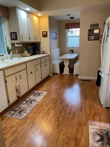a kitchen with sink cabinets and wooden floor