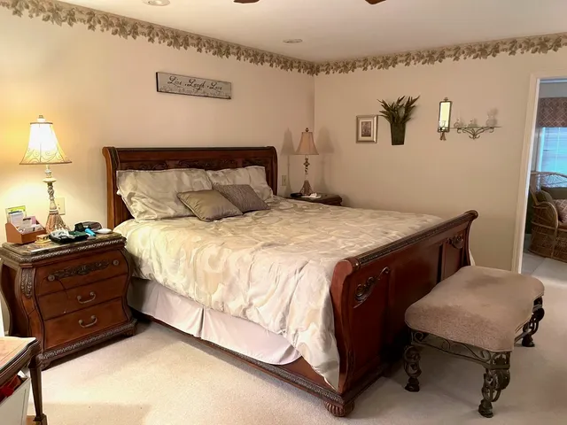 a bedroom with a bed and a lamp on table