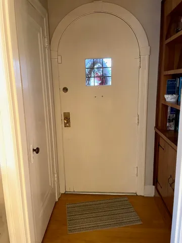 a view of an entryway with wooden floor