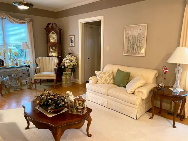 a living room with furniture and a chandelier