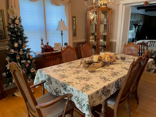 a view of a dining room with furniture and wooden floor
