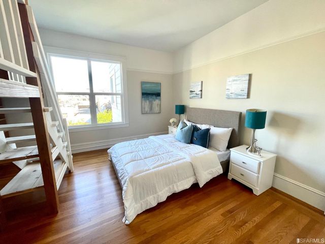 a living room with fireplace furniture and a large window