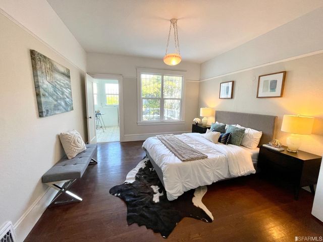 a view of a dining room with furniture and a potted plant