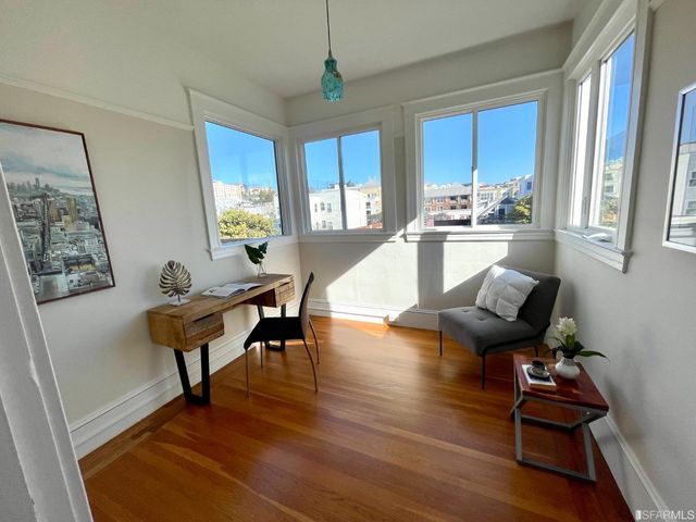 a view of a dining room with furniture and a chandelier