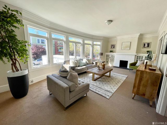 a living room with fireplace furniture and a fireplace