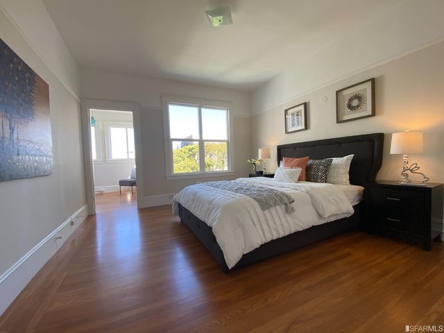 a view of a dining room with furniture a chandelier and wooden floor
