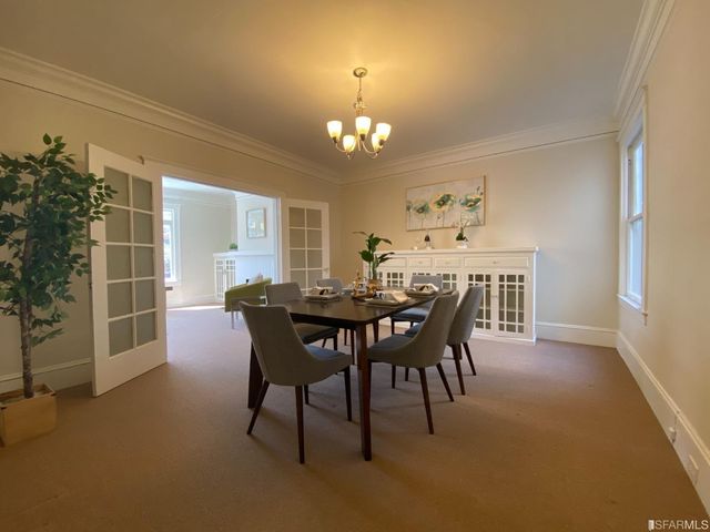 a view of a patio with table and chairs and wooden floor