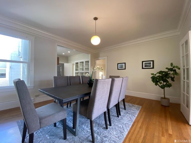 a view of a hallway with wooden floor and windows