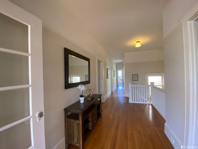 a kitchen with stainless steel appliances granite countertop a stove a sink dishwasher and a microwave oven with wooden floor