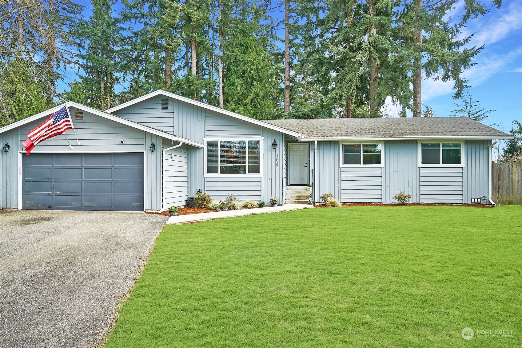 a front view of a house with a garden