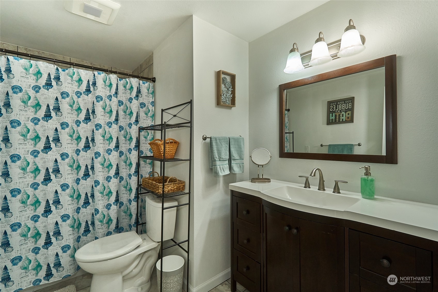 108 183rd Street Southwest Bothell, WA 98012 - Photo 17 of 22 a bathroom with a toilet a sink a mirror a window and a shower