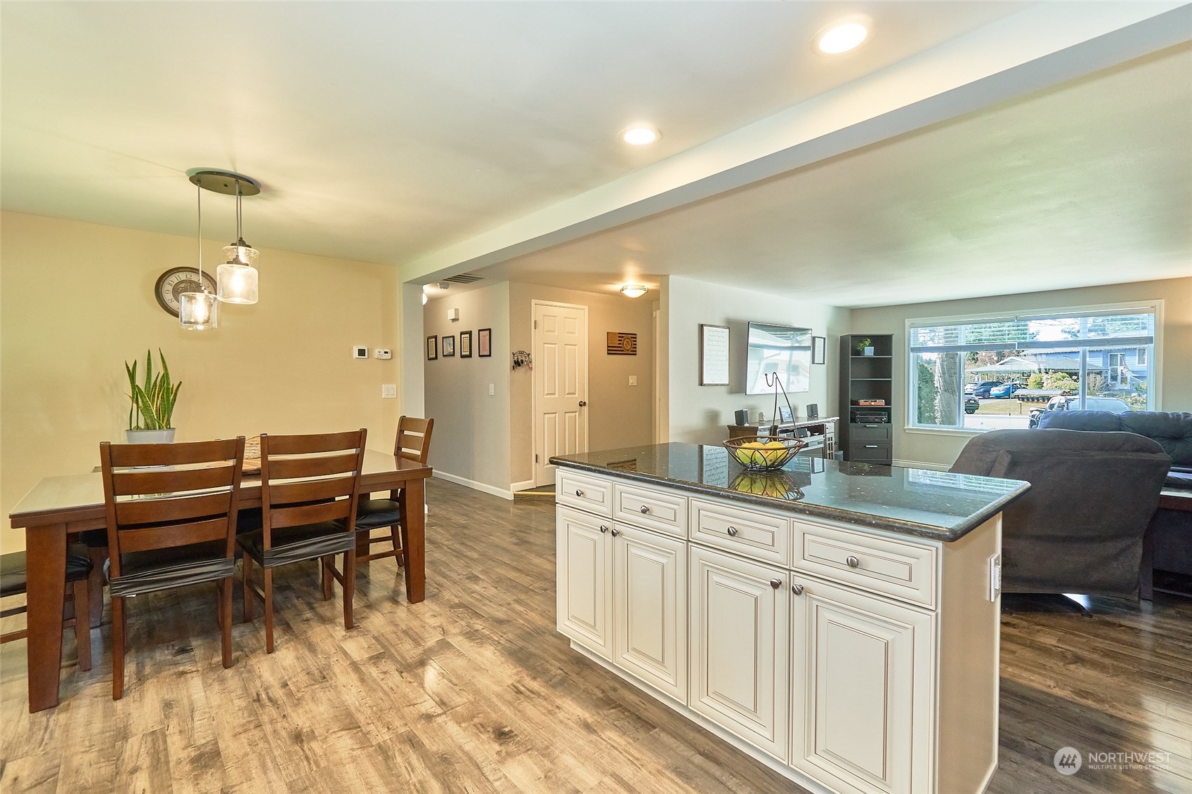 108 183rd Street Southwest Bothell, WA 98012 - Photo 7 of 22 a dining hall with stainless steel appliances kitchen island granite countertop a table and chairs in it