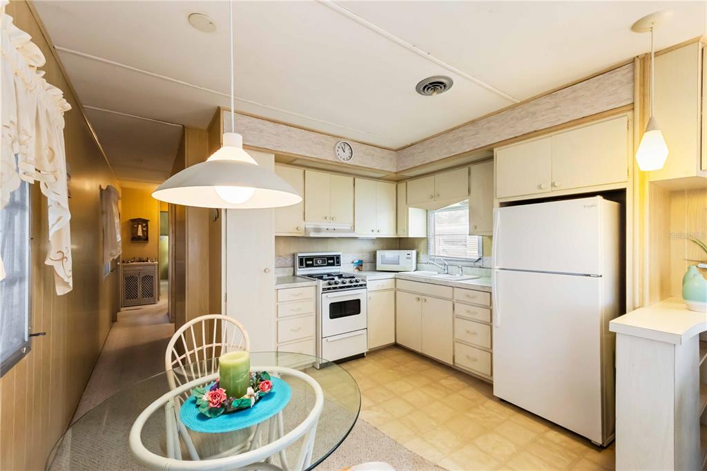 239 Inner Drive East Venice, FL 34285 - Photo 12 of 48 a kitchen with a white stove top oven and refrigerator