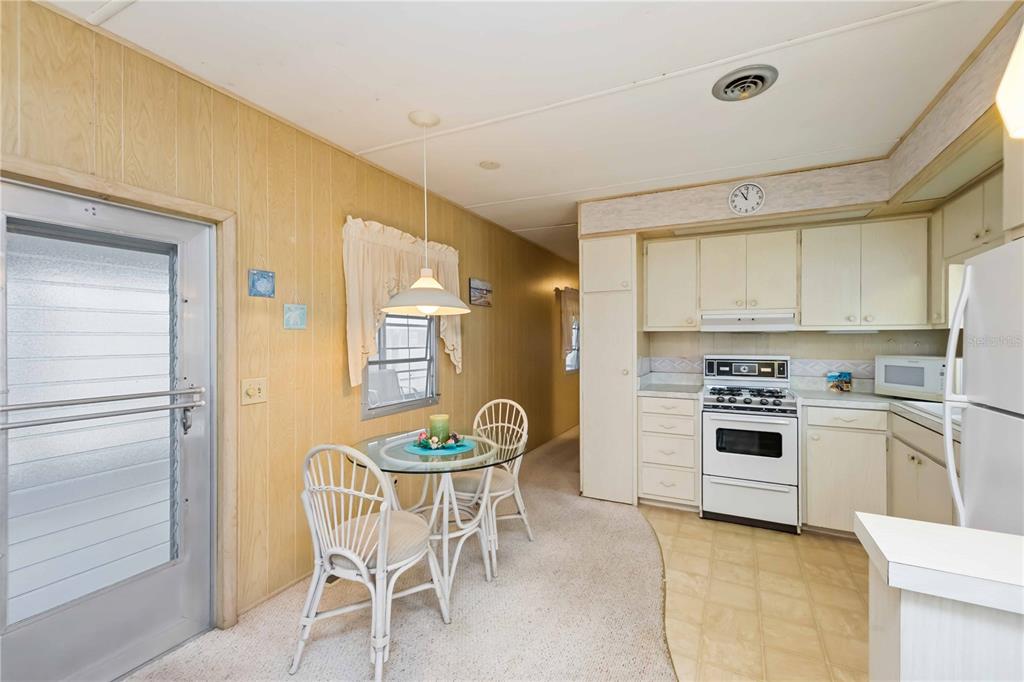 239 Inner Drive East Venice, FL 34285 - Photo 15 of 48 a kitchen with a table chairs and a refrigerator