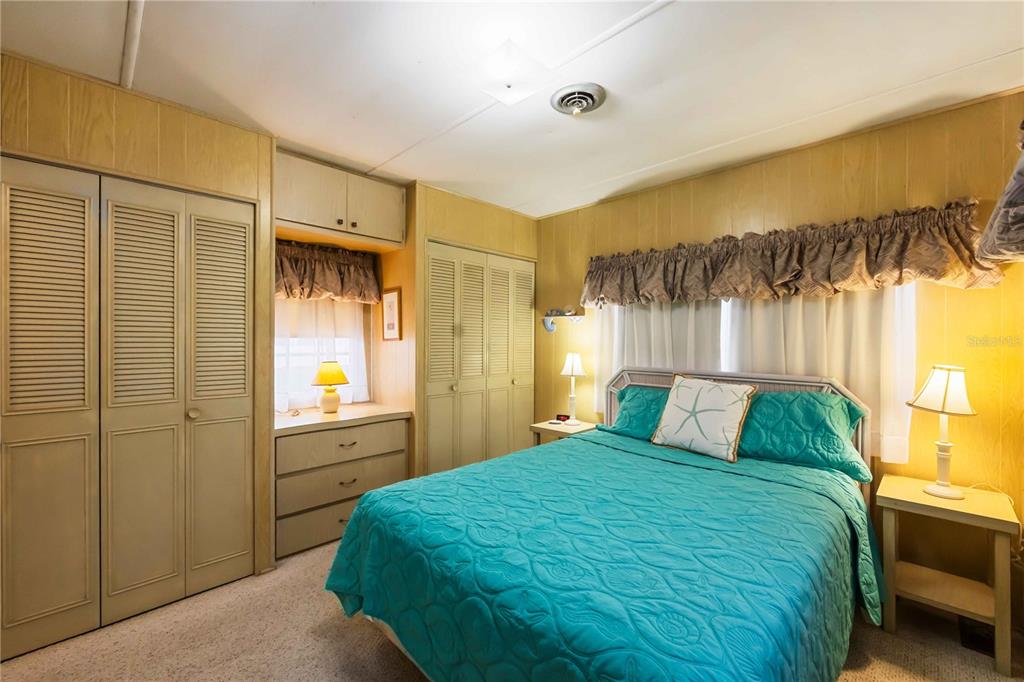 239 Inner Drive East Venice, FL 34285 - Photo 19 of 48 a bedroom with a bed and a chandelier