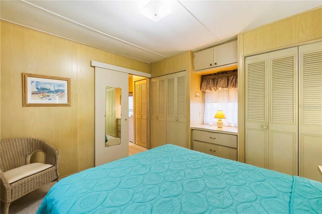 239 Inner Drive East Venice, FL 34285 - Photo 21 of 48 a bedroom with a bed and a couch