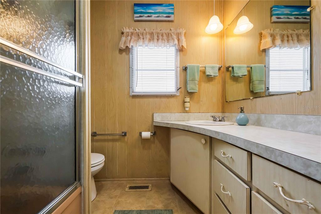 239 Inner Drive East Venice, FL 34285 - Photo 23 of 48 a bathroom with a sink mirror and a toilet