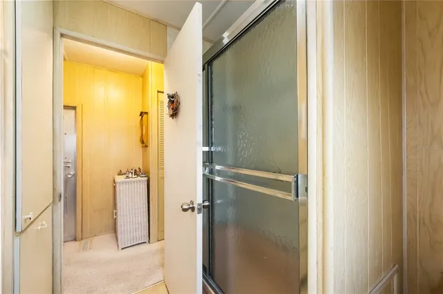 a bathroom with a glass shower door