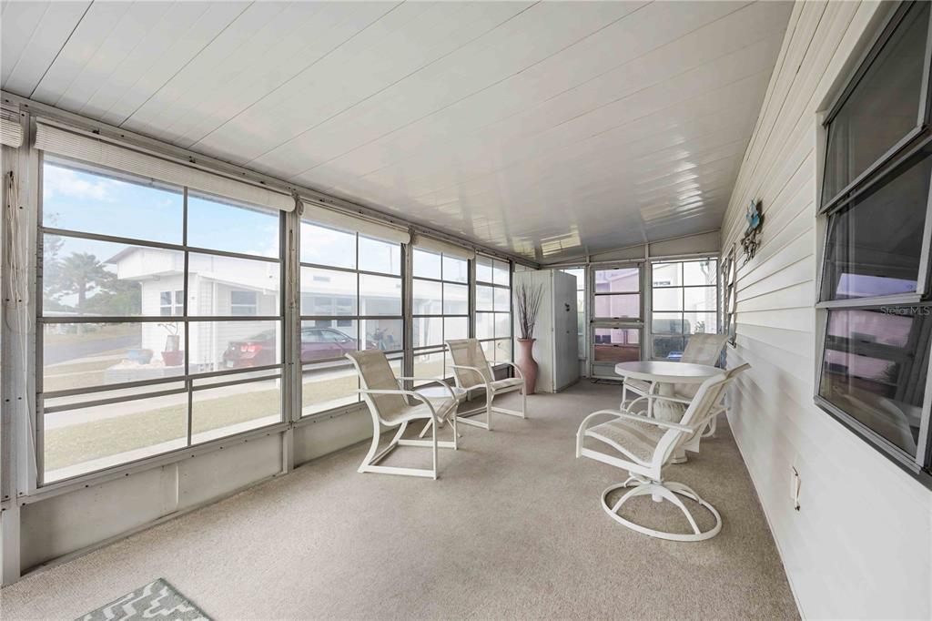 239 Inner Drive East Venice, FL 34285 - Photo 30 of 48 a work room with furniture a flat screen tv and a large window